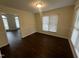 Bright dining room featuring dark hardwood flooring and natural light through large windows at 3624 Singleleaf Ln, Raleigh, NC 27616