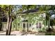 Rear exterior view of a two-story home with green siding, a garage, and a patio area at 3624 Singleleaf Ln, Raleigh, NC 27616