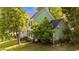 Side view of a two-story home with green siding, black shutters, and a well-manicured yard at 3624 Singleleaf Ln, Raleigh, NC 27616