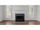 Living room with a classic fireplace and hardwood floors at 3624 Singleleaf Ln, Raleigh, NC 27616