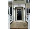 Close-up of the front door with white trim, black hardware, and decorative sconces on either side at 3624 Singleleaf Ln, Raleigh, NC 27616