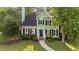 Charming two-story home with green siding, black shutters, and a well-manicured front yard at 3624 Singleleaf Ln, Raleigh, NC 27616