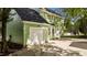 Exterior of a two-car garage and home with green siding and a concrete driveway at 3624 Singleleaf Ln, Raleigh, NC 27616
