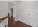 Bright hallway with wood flooring, white walls, and multiple doorways at 3624 Singleleaf Ln, Raleigh, NC 27616