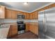 Updated kitchen with stainless steel appliances, wooden cabinets, and a functional layout at 3624 Singleleaf Ln, Raleigh, NC 27616