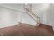 Bright living room with staircase, hardwood floors, and neutral walls create a welcoming atmosphere at 3624 Singleleaf Ln, Raleigh, NC 27616