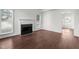 View of a living room with hardwood floors, a fireplace, and large windows at 3624 Singleleaf Ln, Raleigh, NC 27616