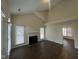 Spacious living room with a fireplace, large windows, and neutral wall color and flooring at 3624 Singleleaf Ln, Raleigh, NC 27616
