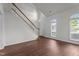 Airy living room features hardwood floors, staircase, and many windows for natural light at 3624 Singleleaf Ln, Raleigh, NC 27616