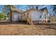 Rustic home featuring a wooden deck and a spacious backyard with mature trees at 404 Cherry St, Oxford, NC 27565