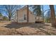 The backyard with a house featuring a brick chimney, wooden deck, and a small porch at 404 Cherry St, Oxford, NC 27565