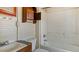Bathroom featuring vintage toilet, sink, bathtub, and shower with practical built in storage at 404 Cherry St, Oxford, NC 27565