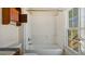 Classic bathroom with a vintage bathtub and shower combo, and a bright window at 404 Cherry St, Oxford, NC 27565