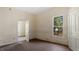 A spacious bedroom with a large window and hardwood floors showcases potential and natural light at 404 Cherry St, Oxford, NC 27565