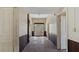 Long hallway featuring original architectural details and bright entry door at the end at 404 Cherry St, Oxford, NC 27565