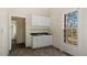 Compact kitchen featuring white cabinets, a double sink, and a window offering natural light at 404 Cherry St, Oxford, NC 27565