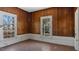 Sunlit living room with classic wood paneled walls, moldings, and bright windows at 404 Cherry St, Oxford, NC 27565