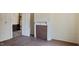 Neutral living room featuring a decorative fireplace, light walls, and a doorway leading to another room at 404 Cherry St, Oxford, NC 27565