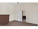 Clean living room with a decorative fireplace, light walls, hardwood floors, and an open doorway at 404 Cherry St, Oxford, NC 27565