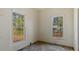 Cozy room with dual windows providing ample natural light and a view of the surrounding trees at 404 Cherry St, Oxford, NC 27565