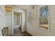 Bright sunroom with an interior door leading to a bathroom with a bathtub and bright window at 404 Cherry St, Oxford, NC 27565
