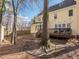 Backyard featuring the home's deck, large trees, and string lights at 4617 Atterbury Ct, Raleigh, NC 27604