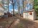 Backyard featuring the home's deck, trees, a shed and a stone path at 4617 Atterbury Ct, Raleigh, NC 27604