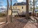 Backyard featuring the home's deck, large trees, and string lights at 4617 Atterbury Ct, Raleigh, NC 27604