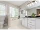 Inviting bathroom boasts a soaking tub, double vanity, and ample natural light from a large window at 4617 Atterbury Ct, Raleigh, NC 27604