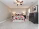 Bright bedroom features neutral paint, ceiling fan, and a large bed with colorful floral bedding at 4617 Atterbury Ct, Raleigh, NC 27604
