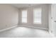 Neutral spare bedroom with carpet, and two windows provides ample natural light at 4617 Atterbury Ct, Raleigh, NC 27604