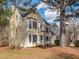 Charming two-story yellow home with black shutters, a quaint porch, and mature trees in the front yard at 4617 Atterbury Ct, Raleigh, NC 27604