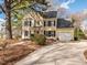 Charming yellow two-story home with a well-maintained front yard and attached garage at 4617 Atterbury Ct, Raleigh, NC 27604
