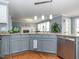 Charming kitchen view with stainless steel appliances, gray cabinets, and granite countertops at 4617 Atterbury Ct, Raleigh, NC 27604