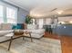 Open-concept living space with a comfortable sofa, stylish rug, and seamless flow to the kitchen area at 4617 Atterbury Ct, Raleigh, NC 27604