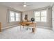 Office featuring neutral paint, carpet, multiple windows and wood furniture at 4617 Atterbury Ct, Raleigh, NC 27604