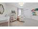 Charming Bedroom with a crib, changing table, and cozy reading nook at 4708 Sweetbriar Dr, Raleigh, NC 27609