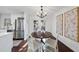 Bright dining area features a round table with seating for four and a modern chandelier at 4708 Sweetbriar Dr, Raleigh, NC 27609