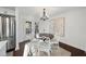 Cozy dining area with hardwood floors, elegant chandelier, and modern stainless steel refrigerator at 4708 Sweetbriar Dr, Raleigh, NC 27609