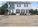 Charming two-story white brick home featuring manicured landscaping and a welcoming entrance at 4708 Sweetbriar Dr, Raleigh, NC 27609
