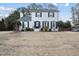 Charming two-story white brick home featuring manicured landscaping and a welcoming entrance at 4708 Sweetbriar Dr, Raleigh, NC 27609