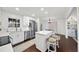 Bright kitchen featuring white cabinets, stainless steel appliances and dark wood flooring at 4708 Sweetbriar Dr, Raleigh, NC 27609