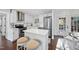 Modern kitchen with white cabinets, stainless steel appliances, and a cozy breakfast bar at 4708 Sweetbriar Dr, Raleigh, NC 27609