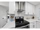 Modern kitchen features white cabinets, stainless steel appliances and subway tile backsplash at 4708 Sweetbriar Dr, Raleigh, NC 27609
