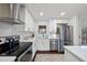 Modern kitchen with stainless steel appliances, white cabinets and an island with breakfast bar at 4708 Sweetbriar Dr, Raleigh, NC 27609