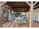 Covered patio with fireplace, TV, and comfortable seating with a view of the backyard at 4708 Sweetbriar Dr, Raleigh, NC 27609