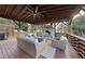 Outdoor covered living space with stone fireplace, ceiling fan, and comfortable seating at 4708 Sweetbriar Dr, Raleigh, NC 27609