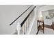 Elegant staircase featuring neutral carpeting, contrasting handrails, and decorative accents at 4708 Sweetbriar Dr, Raleigh, NC 27609