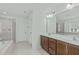 Bathroom featuring a double sink vanity, large mirror, soaking tub and walk-in shower at 4821 Heathshire Dr, Raleigh, NC 27616