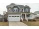 Charming two-story home with a covered front porch and two-car garage at 4821 Heathshire Dr, Raleigh, NC 27616